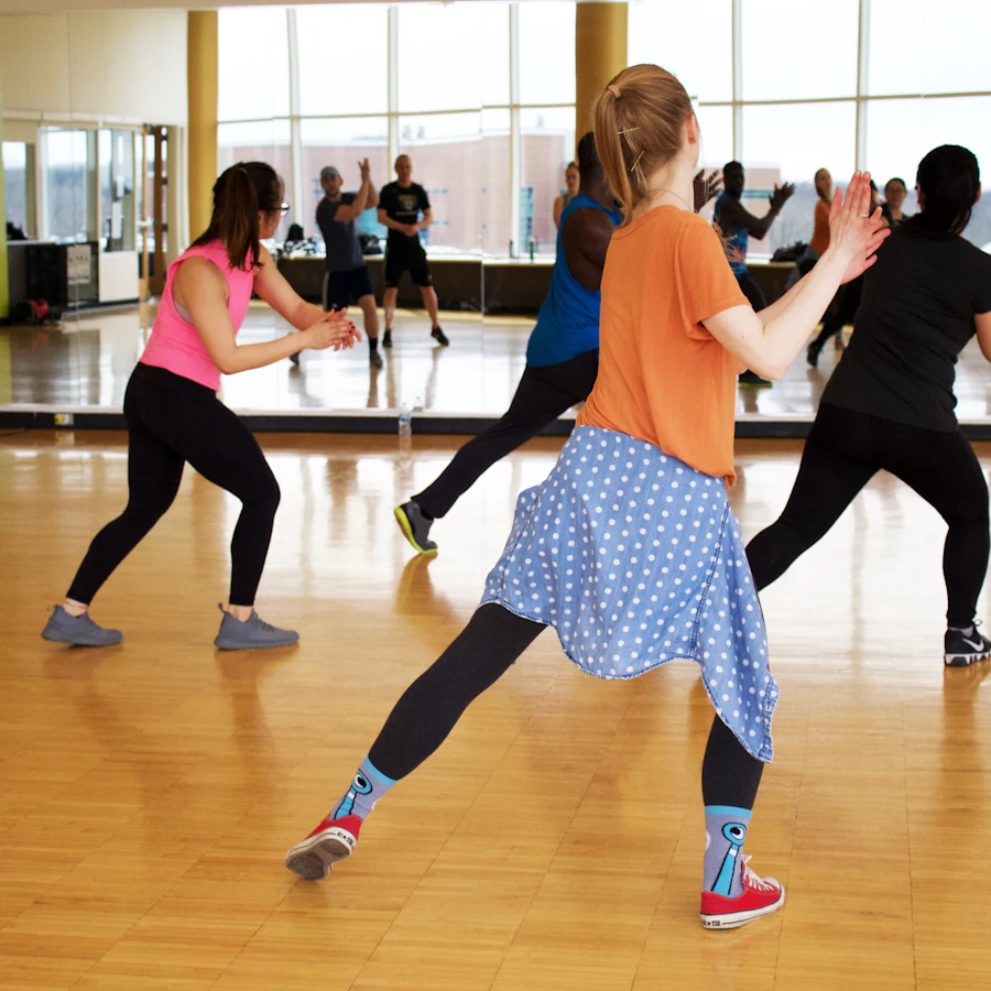 A class dancing together on the studio floor