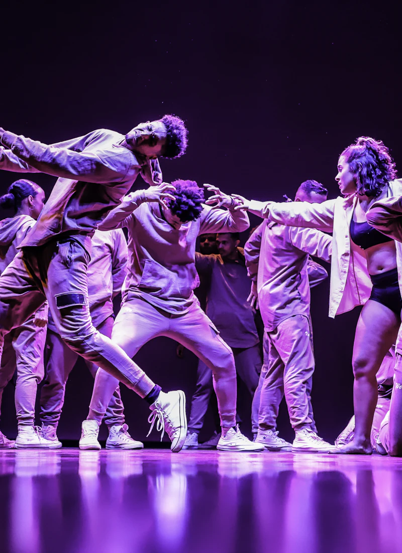 A packed dance floor under stage light